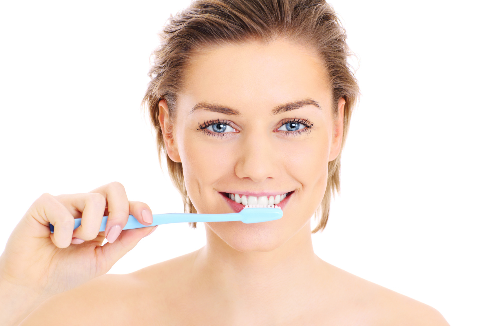 A picture of a young pretty woman brushing her teeth over white background